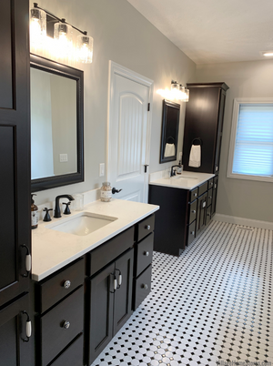 Primary Bathroom With Dark Cabinetry and Classic Black and White Tiles