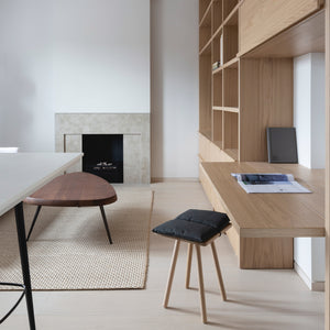 From a mini-fridge to a folding desk and a concealed make-up mirror, this compact London apartment designed by local firm MWAI features a variety of space-saving solutions.